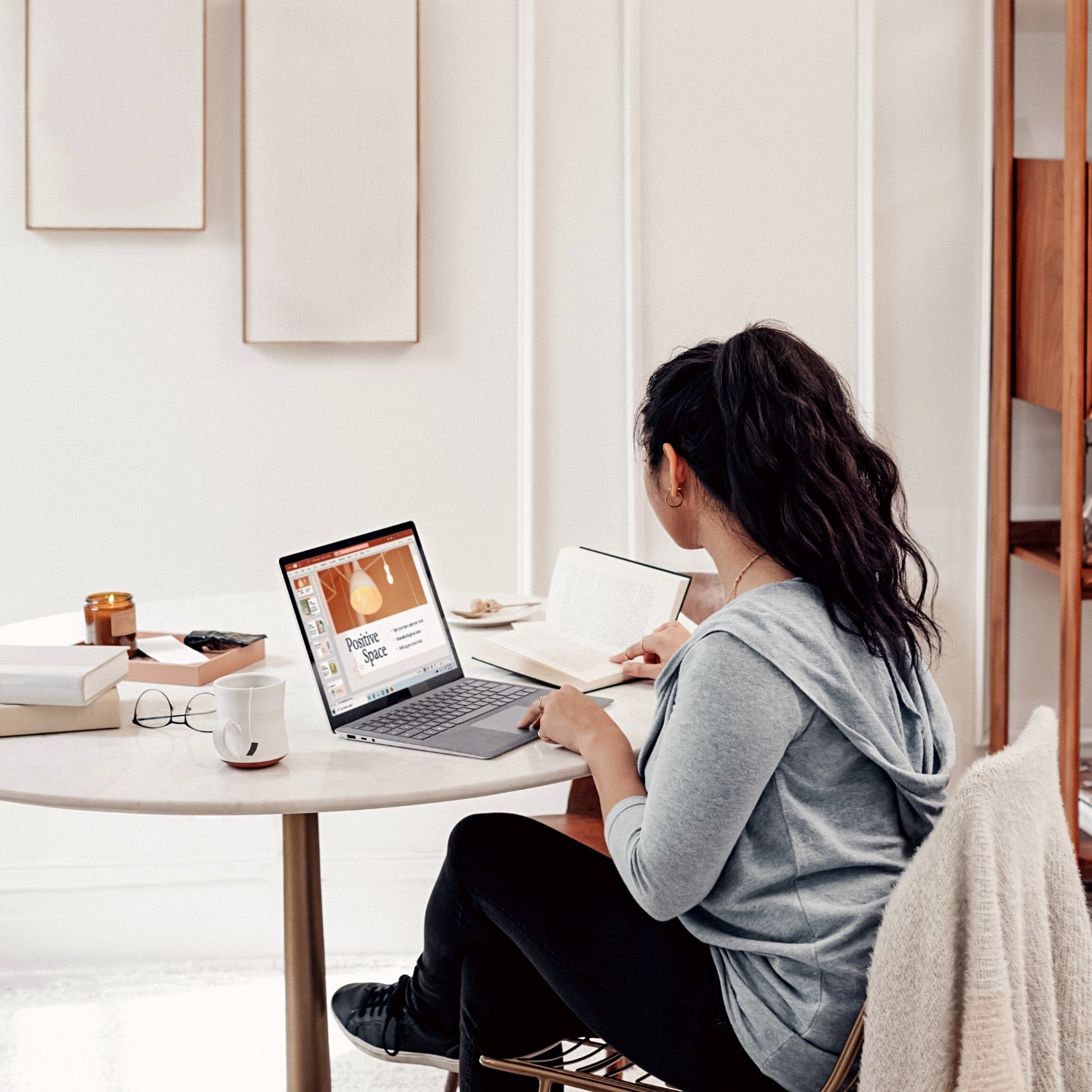 Woman sitting at laptop working on brand style guide